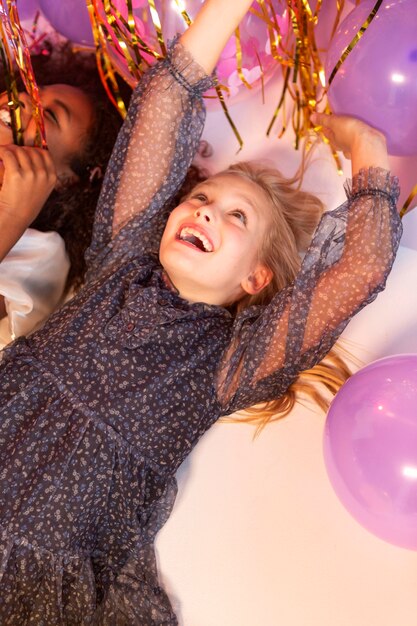 Portrait young girls at party with balloons