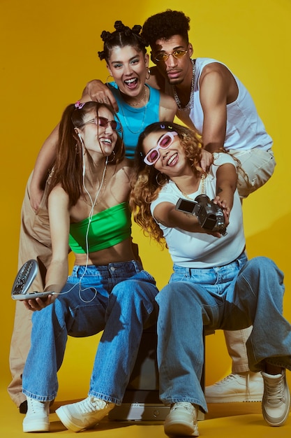 Portrait of young group of friends in 2000s fashion style posing with camera