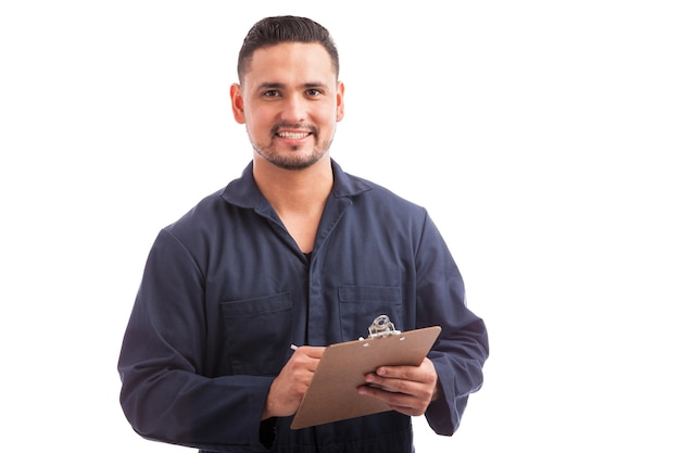 Portrait of a young handsome contractor going through a home inspection on a white background