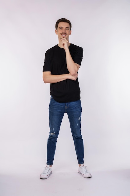 Portrait of young handsome man looking confident at the camera with smile with crossed arms and hand raised on chin over isolated background