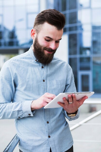 Portrait of a young handsome man using digital tablet