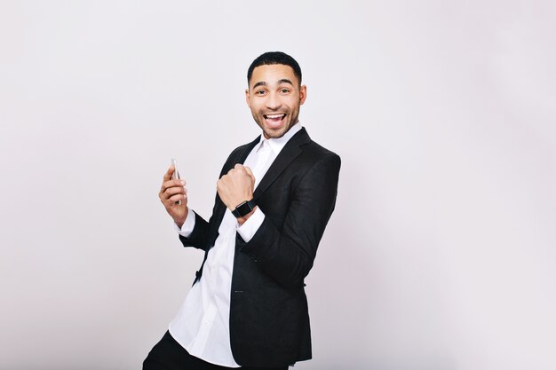 Portrait young handsome man in white shirt, black jacket having fun, smiling. Success, expressing true positive emotions, good results, happiness, smiling.