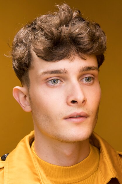 Portrait of young handsome man in a yellow scene