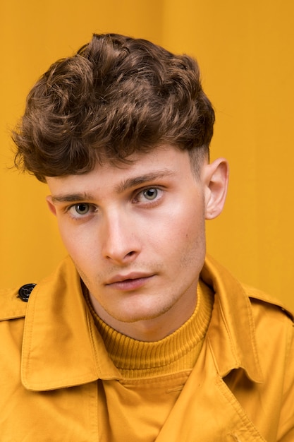 Portrait of young handsome man in a yellow scene