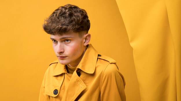 Portrait of young handsome man in a yellow scene