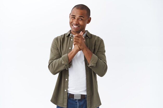 Portrait of young happy african-american man smile and appreciate help, thanking for praises