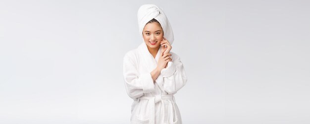 Portrait of a young happy asian lady in bathrobeIsolated in white background