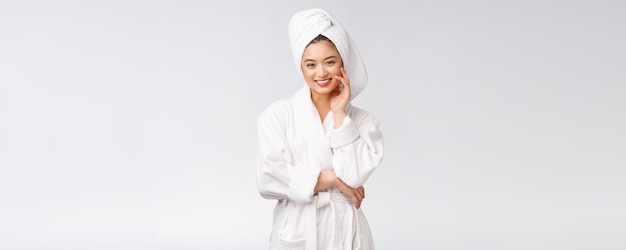 Portrait of a young happy asian lady in bathrobeIsolated in white background