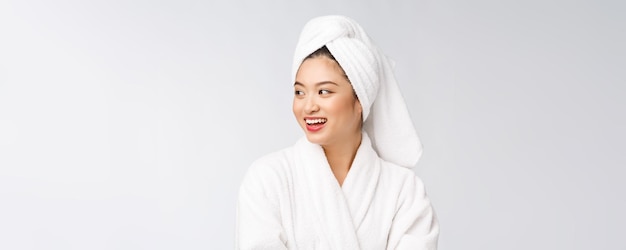 Portrait of a young happy asian lady in bathrobeIsolated in white background