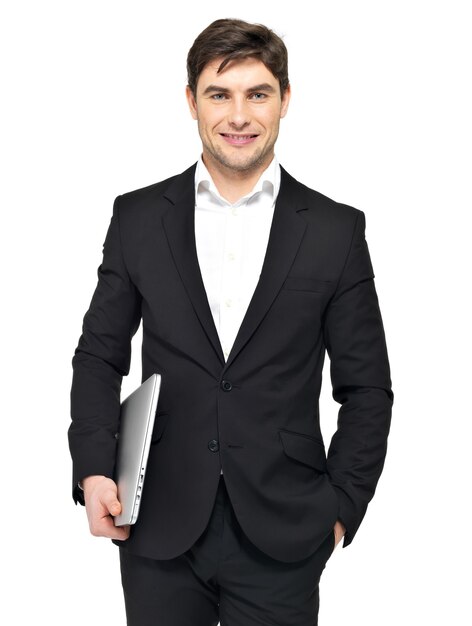 Portrait of young happy businessman holds laptop isolated on white. 
