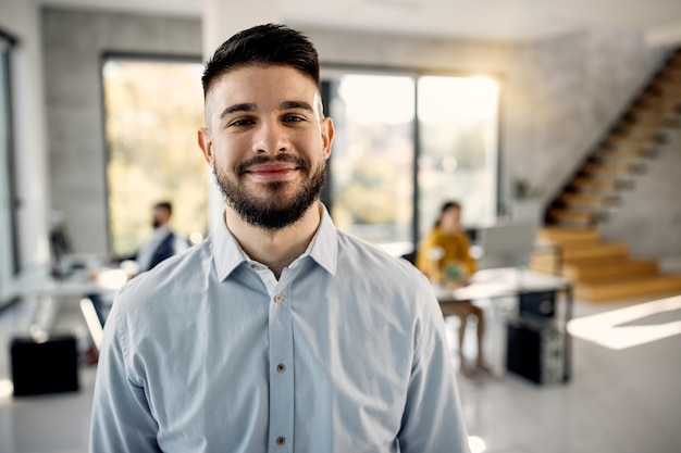 Portrait of young happy businessman in the office