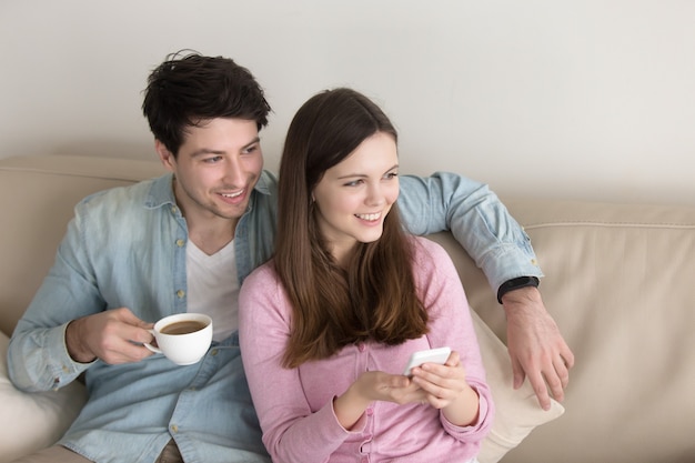 Portrait of young happy couple relaxing indoors