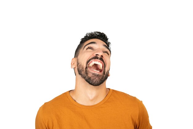 Portrait of young happy man smiling against white space