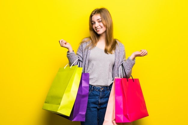 Portrait of young happy smiling teen girl with shopping bags, isolated