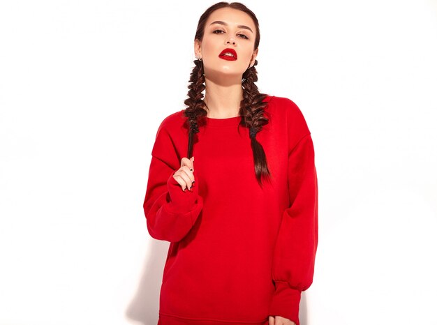 Portrait of young happy smiling woman model with bright makeup and colorful lips with two pigtails and sunglasses in summer red clothes isolated. 