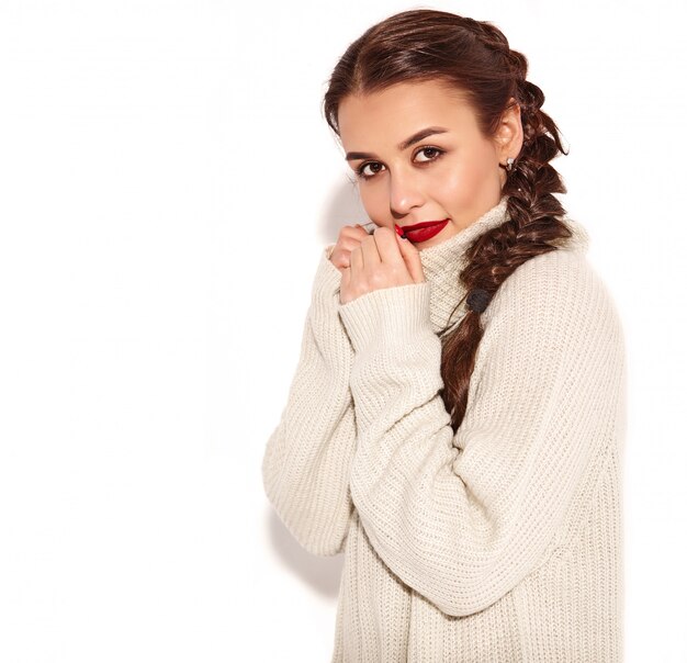 Portrait of young happy smiling woman model with bright makeup and red lips with two pigtails in summer warm sweater clothes isolated. 