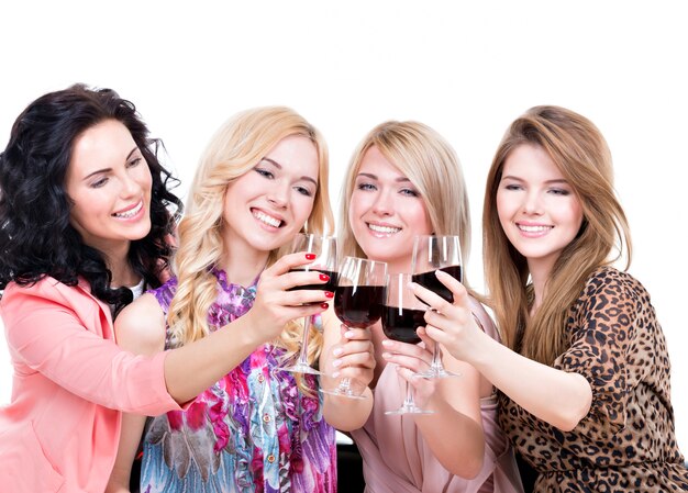 Portrait of young happy women having fun and drinking red wine - isolated on white