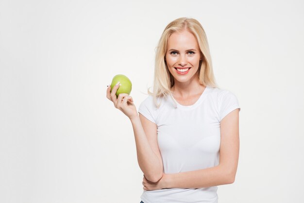 Portrait of a young healthy woman holding green apple