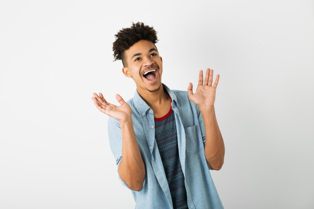 Portrait of young hipster black man posing on isolated white studio wall background, stylish outfit, funny afro hairstyle, smiling, happy, surprised face expression, shocked, funny