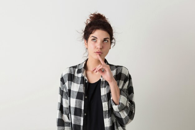 Portrait of young hipster pretty woman in checkered shirt thinking, having a problem, posing isolated on white studio background