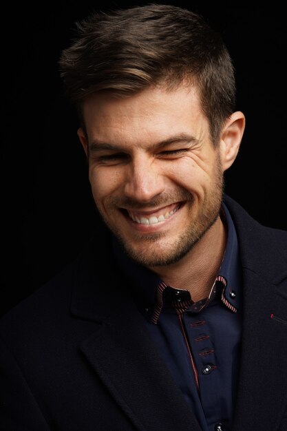 Portrait of a young Hispanic male in a formal outfit with a happy face expression