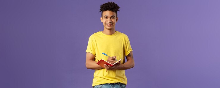 Free Photo portrait of young hispanic male student studying online courses writing down lecture making personal