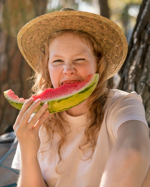 Portrait of young lady eating a slice of watermelon