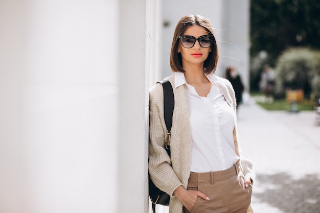 Portrait of a young lady walking outside the city