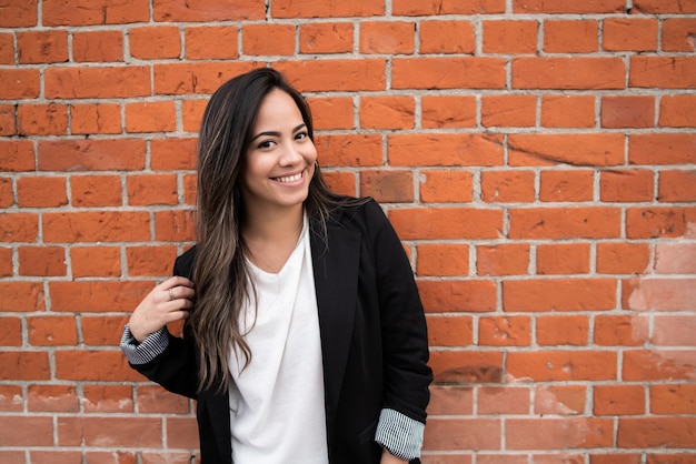 Portrait of young latin woman posing outdoors in the street. Urban concept.