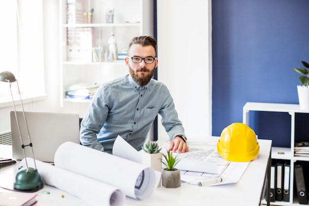 Portrait of young male architect in office