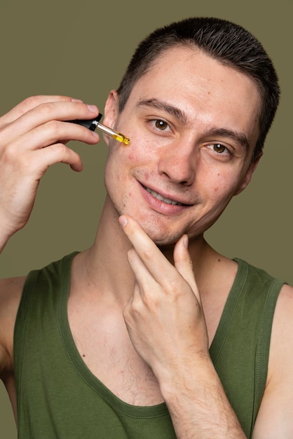 Portrait of young man being confident with acne