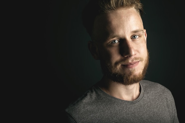 Portrait of young man above black background