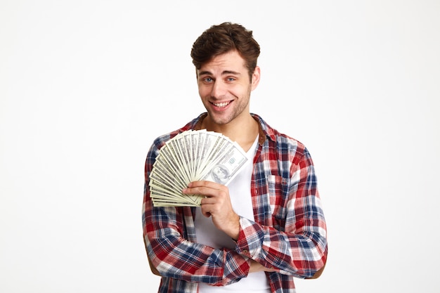 Portrait of a young man holding bunch of money banknotes