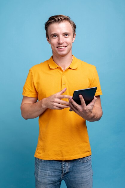 Portrait of young man holding a tablet