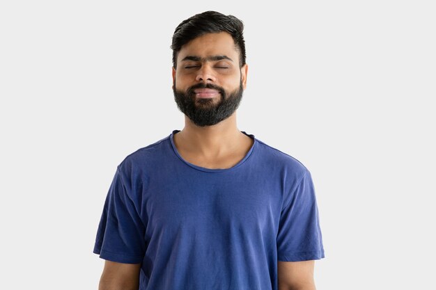 Portrait of young man isolated on white wall