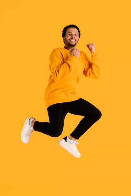 Free photo portrait young man jumping