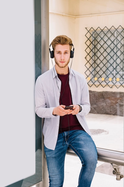 Portrait of a young man listening music