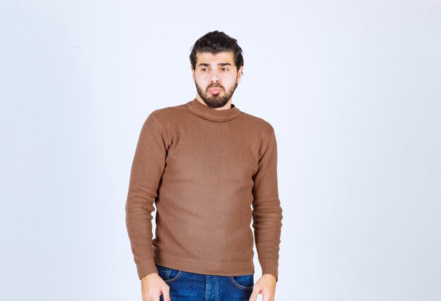 Portrait of a young man model with beard standing and posing . High quality photo