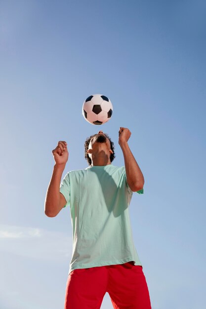 Portrait young man playing football