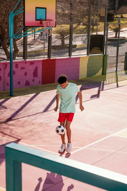 Portrait young man playing football