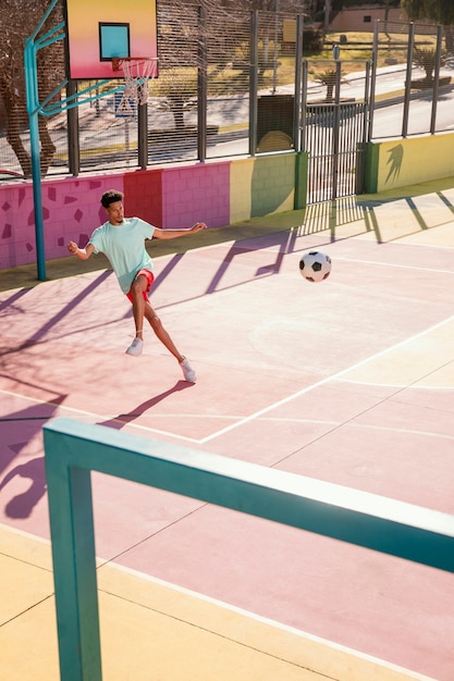 Portrait young man playing football