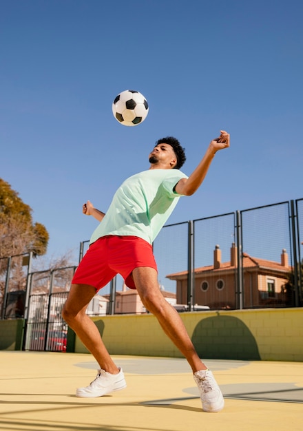 Portrait young man playing football