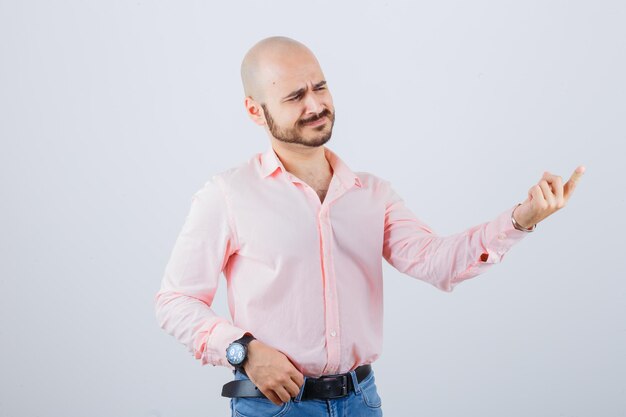 Portrait of young man pointing away