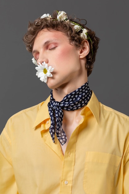 Portrait young man posing with floral wreath