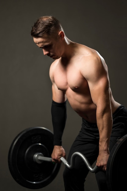 Portrait young man powerlifting at gym