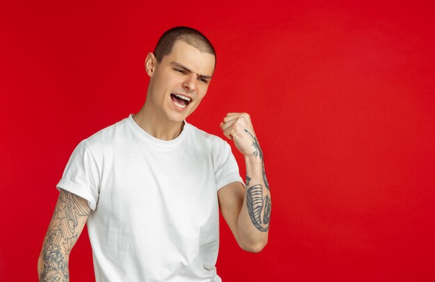 Portrait of young man on red background