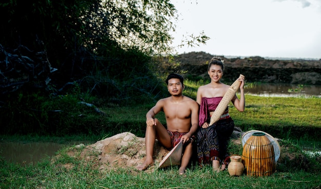 Portrait Young man topless sitting near pretty woman in beautiful clothes in rural lifestyle
