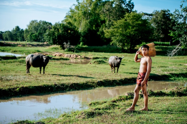 Portrait Young man topless use bamboo fishing trap to catch fish for cooking