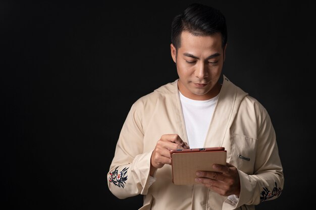 Portrait of young man wearing embroidered shirt