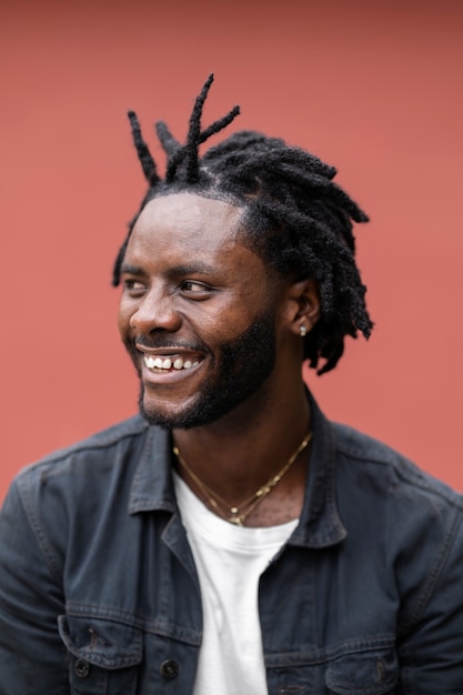 Portrait of young man with afro dreadlocks and jacket